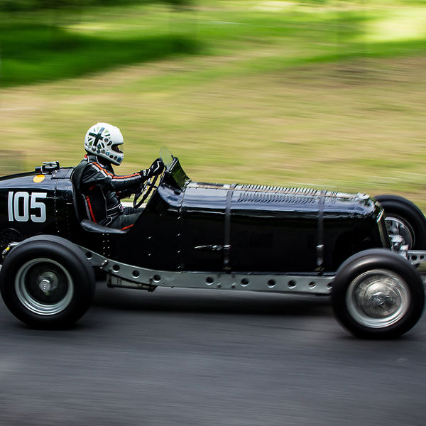 La Vie en Bleu 2019, Prescott Speed Hill Climb, #49 black ERA vintage single seat sports car at speed on prescott hill climb course