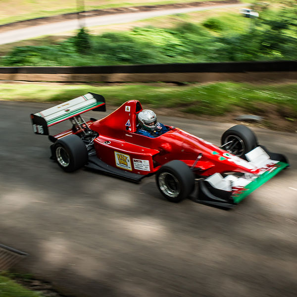 Best of British 2019, Shelsley Walsh, #11 red racing car with welsh dragon livery on shelsley walsh hill climb at speed