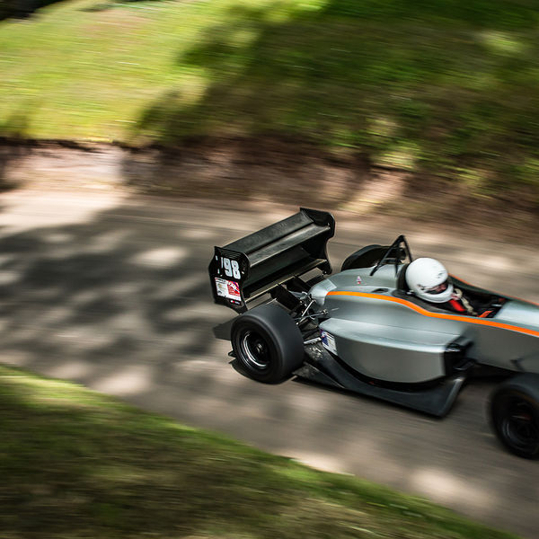 Best of British 2019, Shelsley Walsh, #34 silver and orange single seat racing car on shelsley walsh hill climb at speed