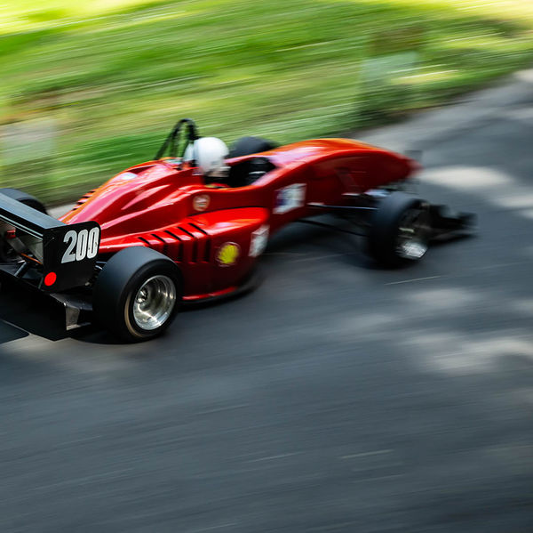 Porsche at Prescott 2019, #62 red single seat race car at speed during the porsche at prescott hill climb event