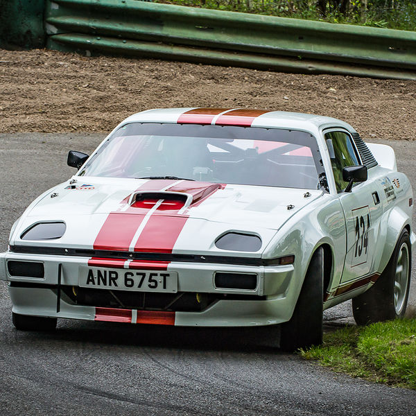 La Vie en Bleu 2019, Prescott Speed Hill Climb, #44 red and white triumph tr7 classic sports car rounding the hairpin at prescott hill climb