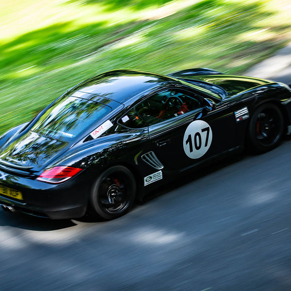 Porsche at Prescott 2019, #69 black porsche cayman at speed during the porsche at prescott hill climb event
