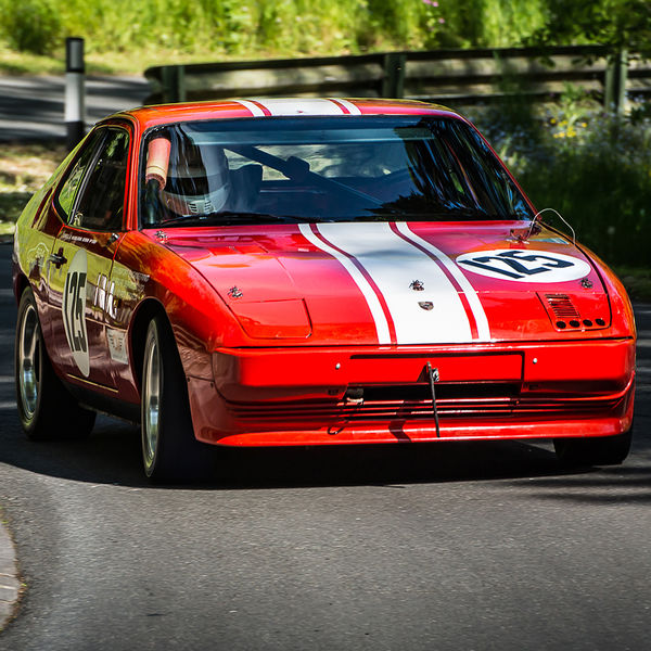 La Vie en Bleu 2019, Prescott Speed Hill Climb, #15 red classic porsche 924 racing car at speed under the trees on prescott hill climb