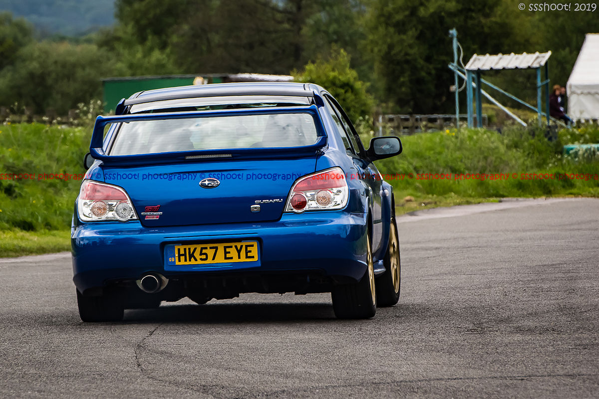 Blue Subaru Impreza exiting the hairpin at speed on Curborough Sprint Course