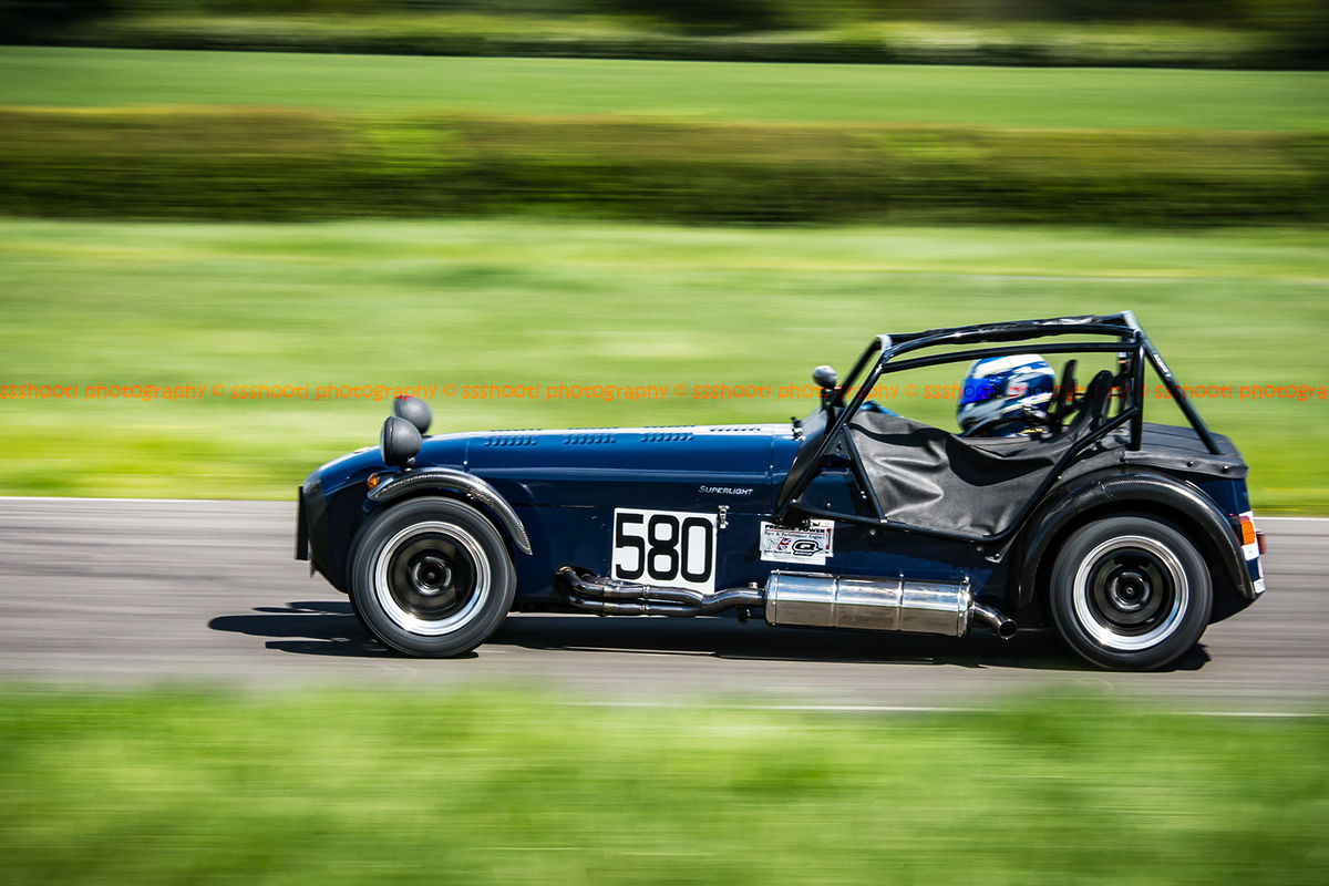 Dark Blue Caterham 7 at speed along the Curborough sprint course shenstone straight