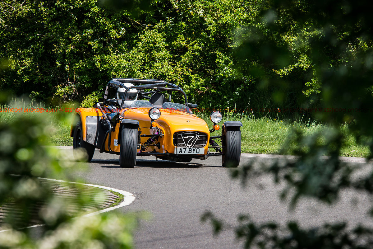 orange caterham 7 rounding the fradley hairpin corner at curborough sprint track