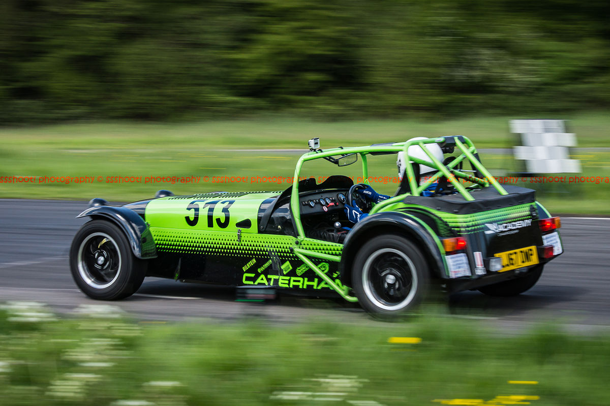 Bright green Caterham 7 at speed along the Curborough sprint course shenstone straight