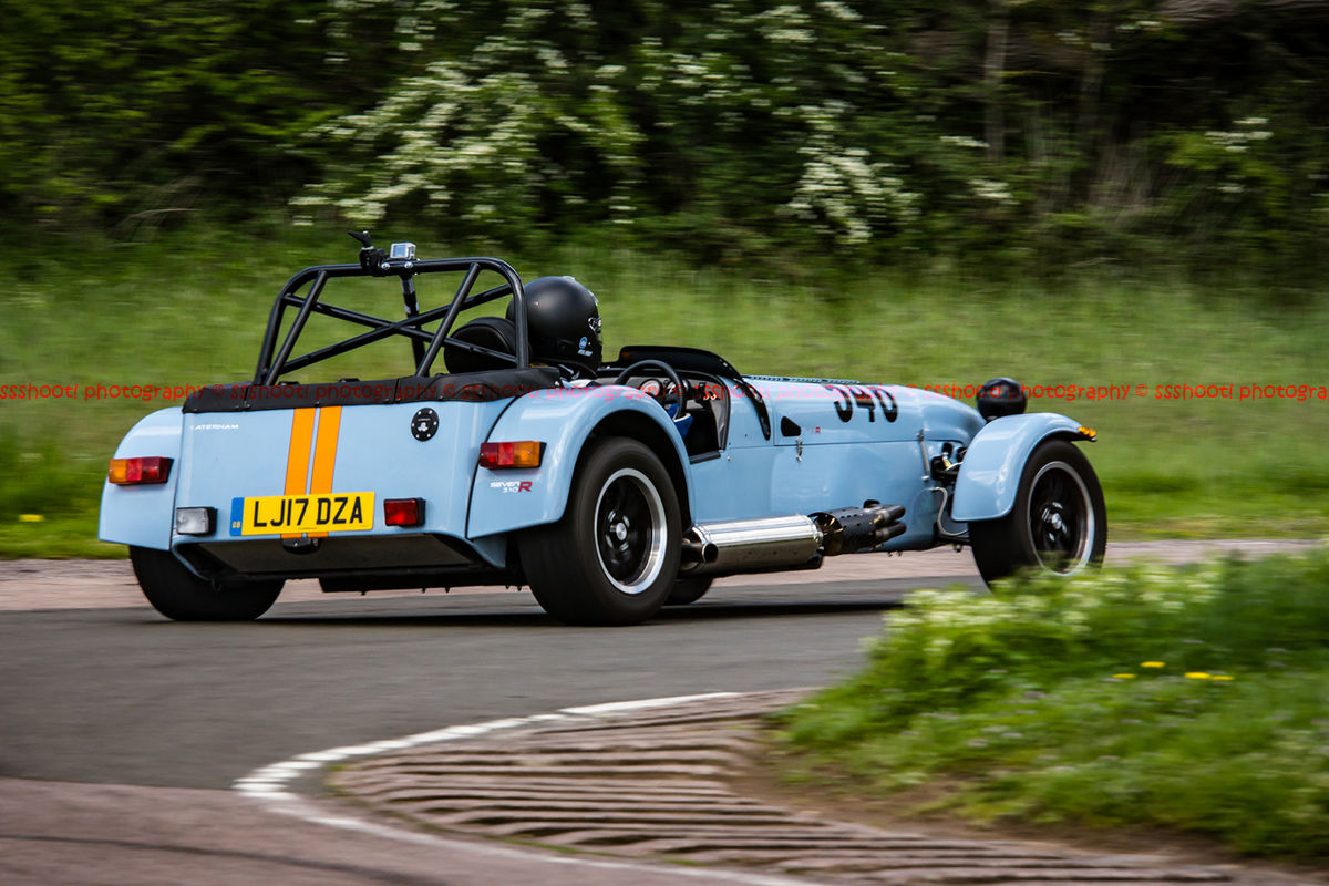 Caterham 7 in gulf racing colours exiting flagpole corner at curborough sprint course