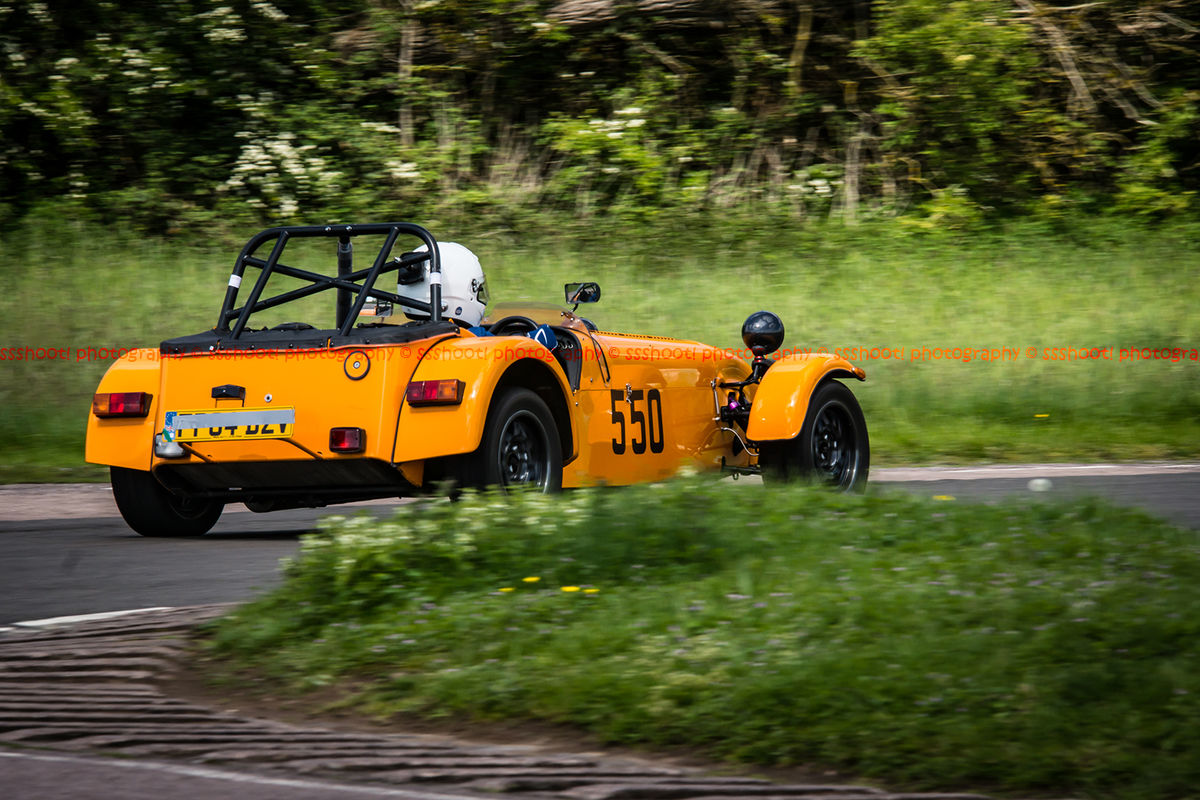 Orange caterham 7 exiting flagpole corner at curborough sprint course