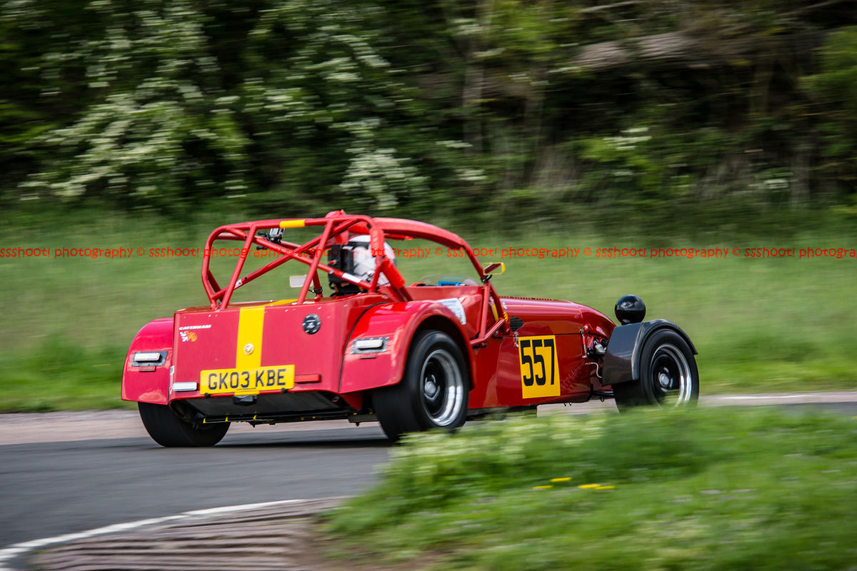Red caterham 7 exiting flagpole corner at curborough sprint course