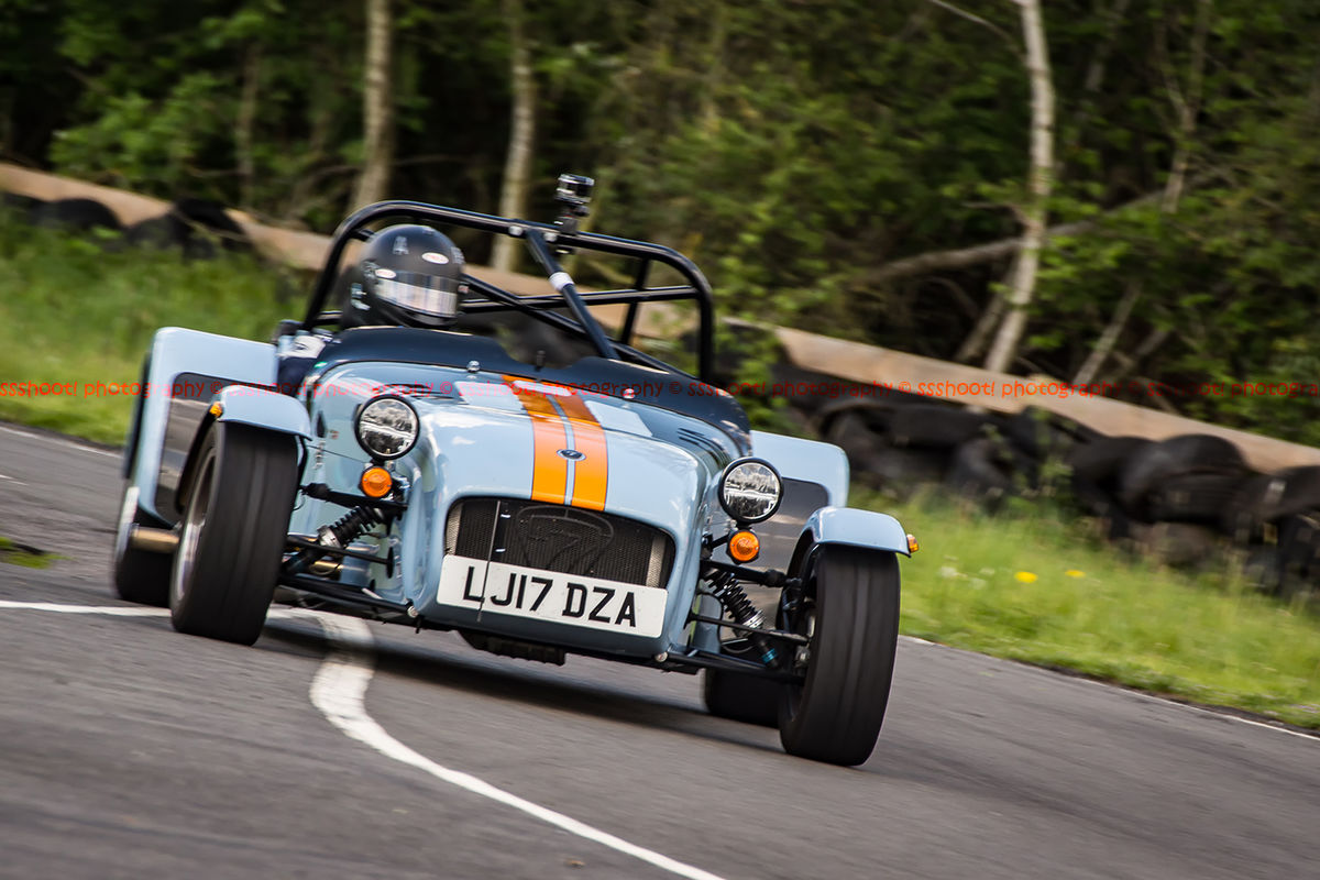 Gulf racing caterham 7 at speed through curborough sprint course mole hill corner