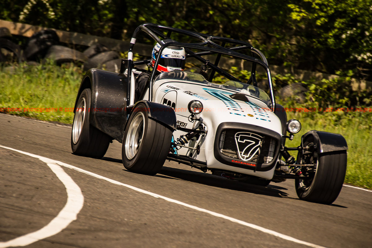 white caterham 7 at speed through curborough sprint course mole hill corner