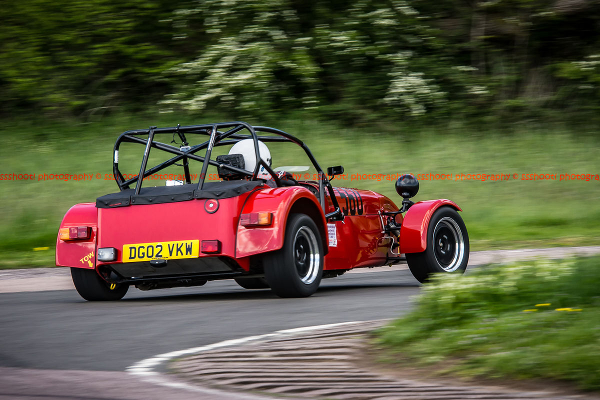 red caterham 7 rounding flag pole corner at curborough sprint track