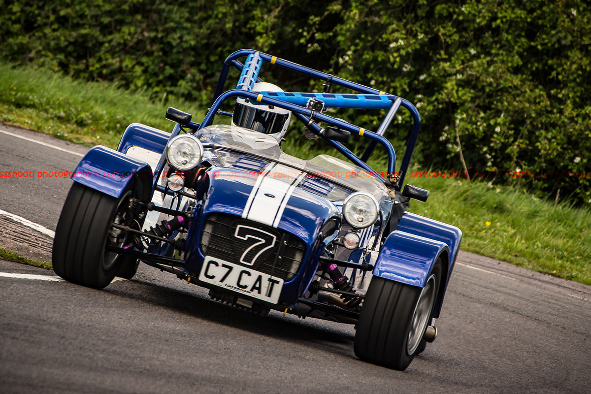 blue caterham 7 rounding the fradley hairpin corner at curborough sprint track