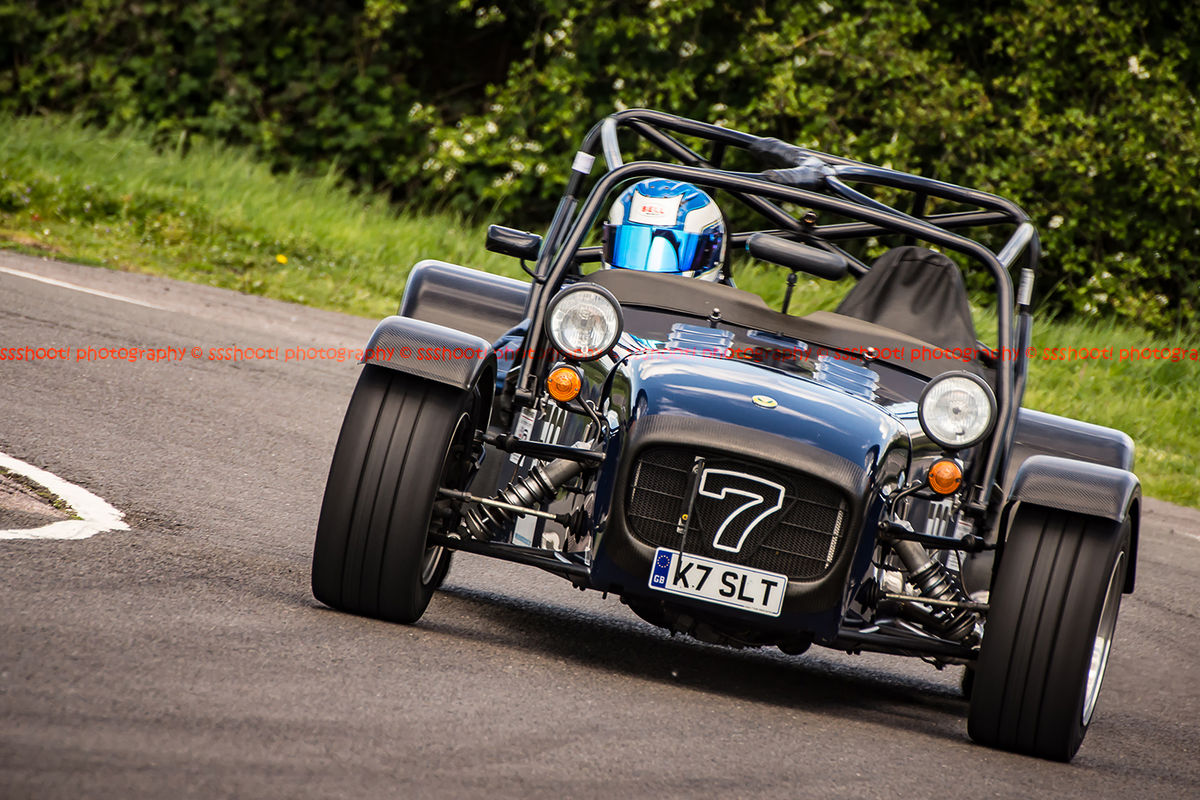 black caterham 7 rounding the fradley hairpin corner at curborough sprint track