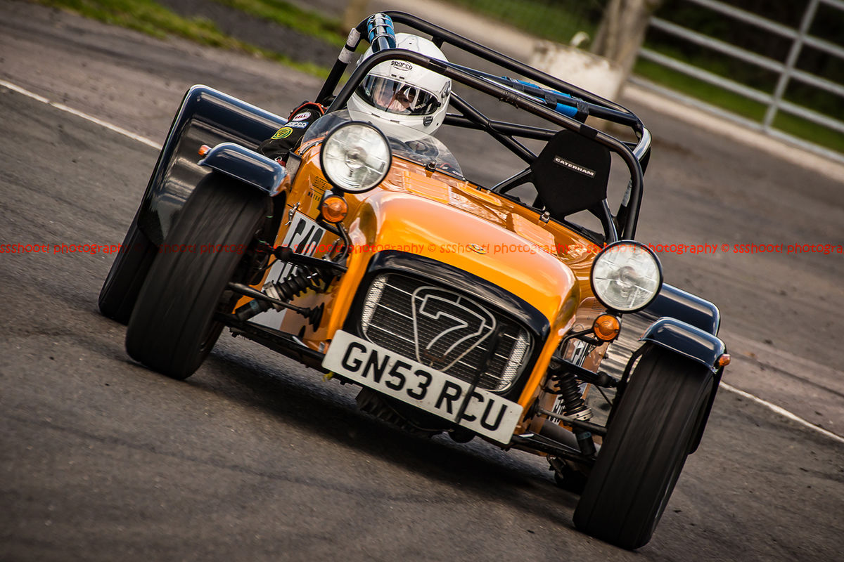 orange caterham 7 rounding the fradley hairpin corner at curborough sprint track