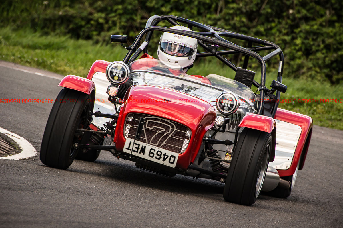 red and aluminium caterham 7 rounding the fradley hairpin corner at curborough sprint track