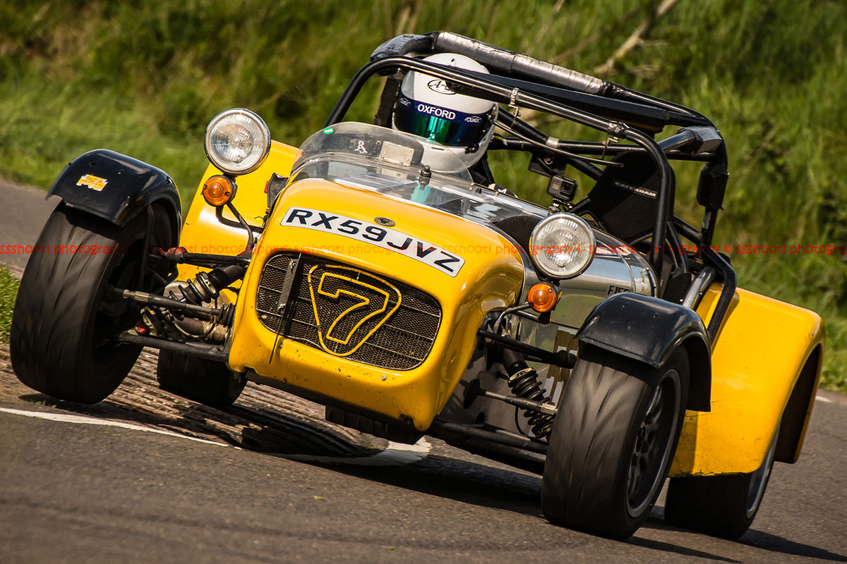 aluminium and yellow caterham 7 rounding the fradley hairpin corner at curborough sprint track