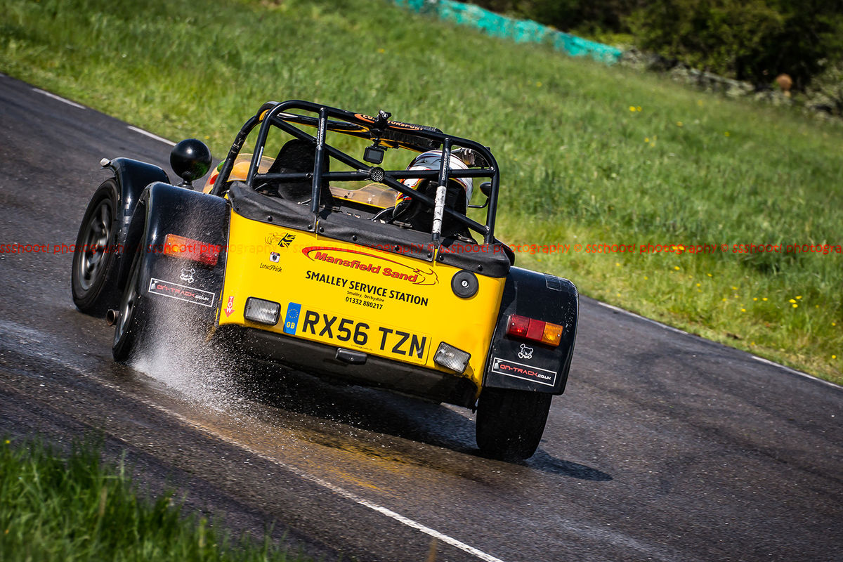 Yellow Lotus 7 Caterham Westfield opposite lock in rain at Curborough Sprint Course