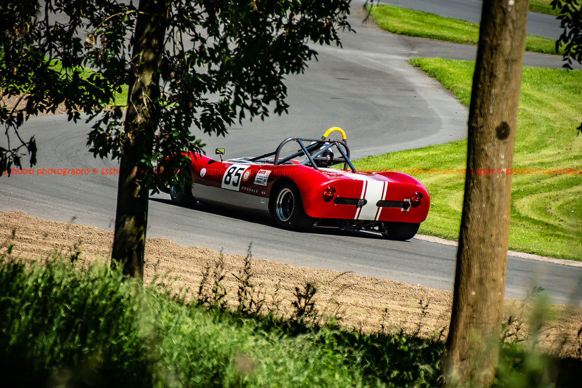red classic sixties race car at speed during the porsche at prescott hill climb event