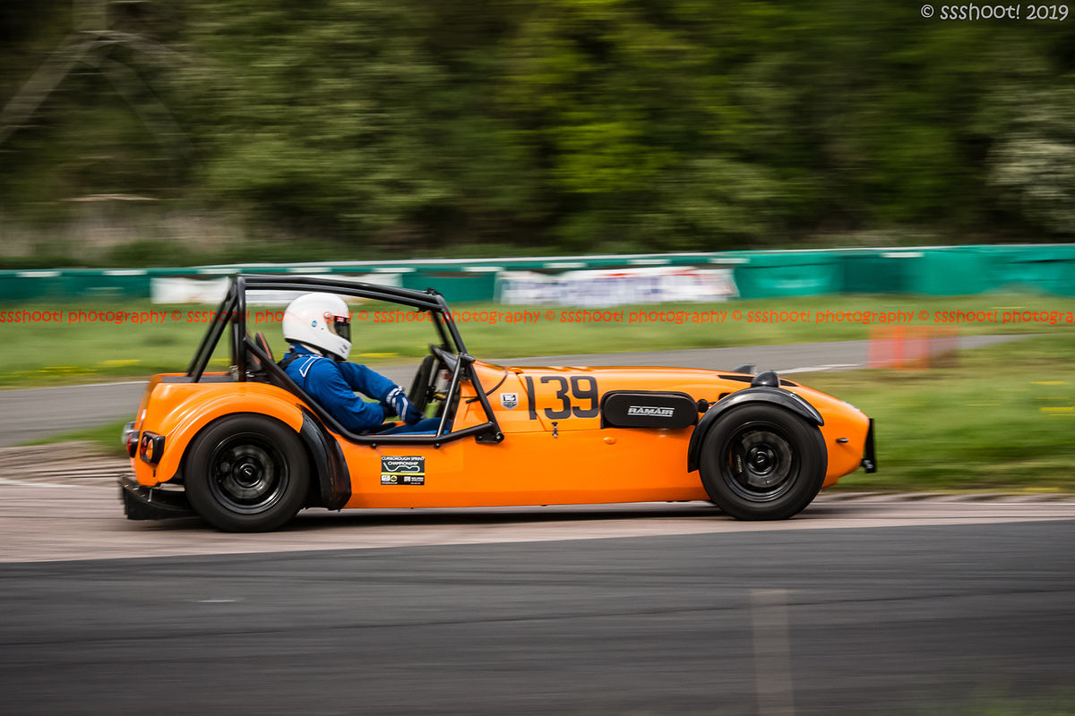 orange lotus 7 caterham westfield at speed on curborough shenstone straight