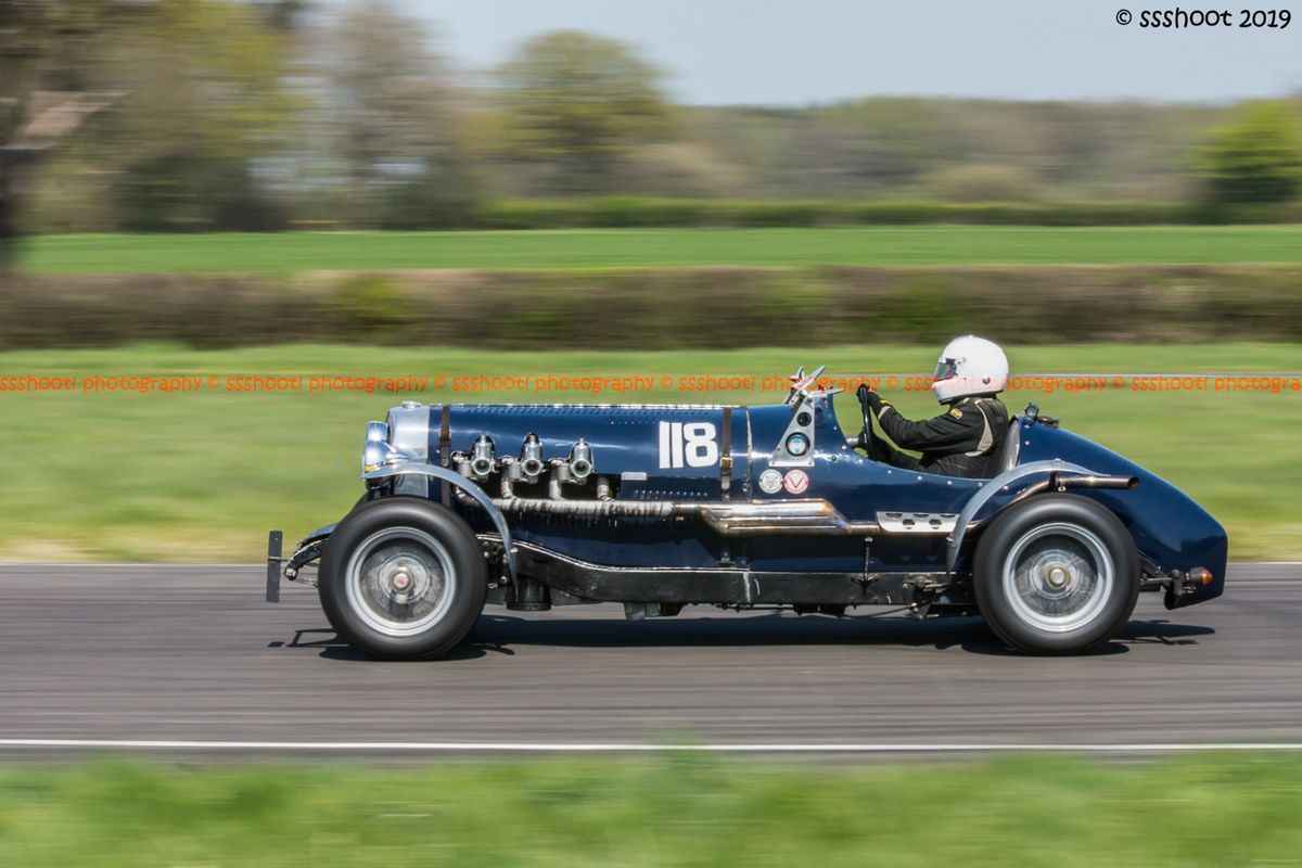 Blue vintage racing car at speed on curborough sprint course