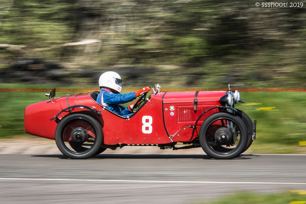 red vintage racing car taking curborough flagpole corner at speed