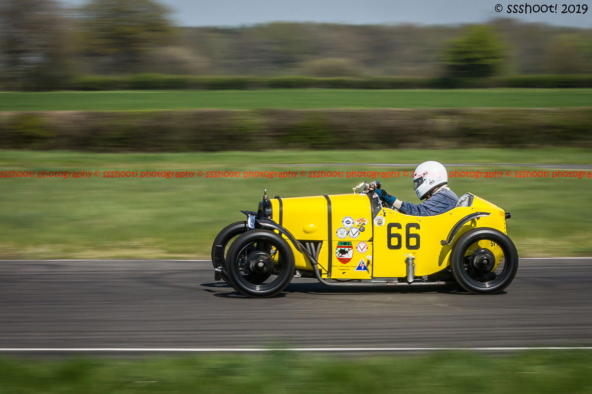 yellow vintage racing car at speed on curborough sprint course