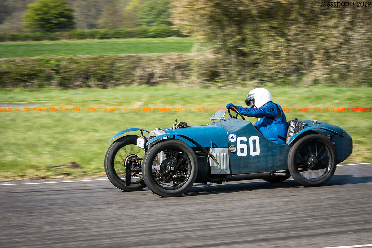 Blue vintage racing car at speed on curborough sprint course