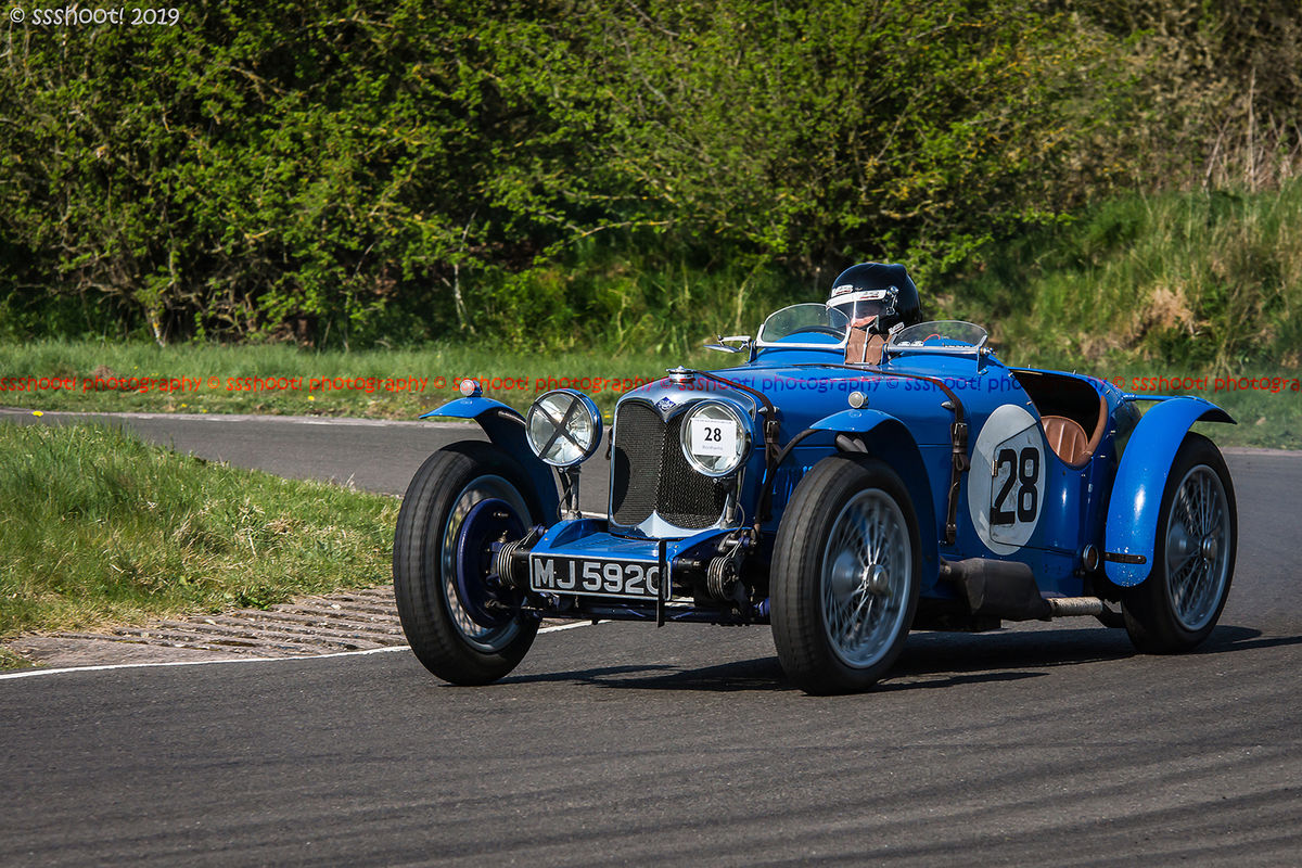 Blue vintage racing car at speed on curborough sprint course