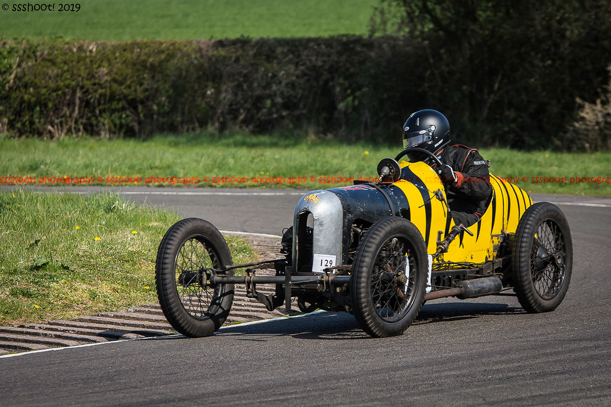 black and yellow striped vintage racing car at speed on curborough sprint course