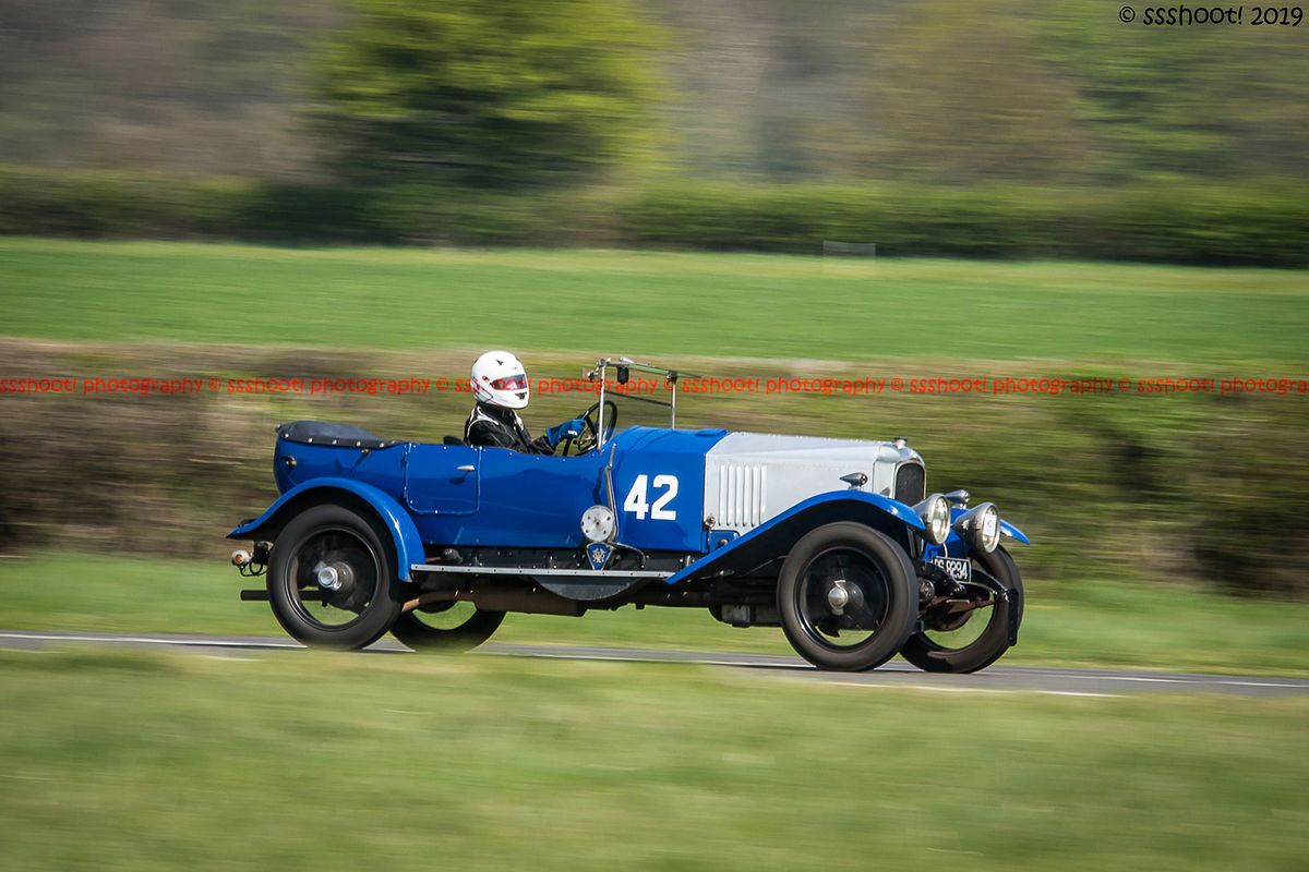 Blue vintage racing car at speed on curborough sprint course