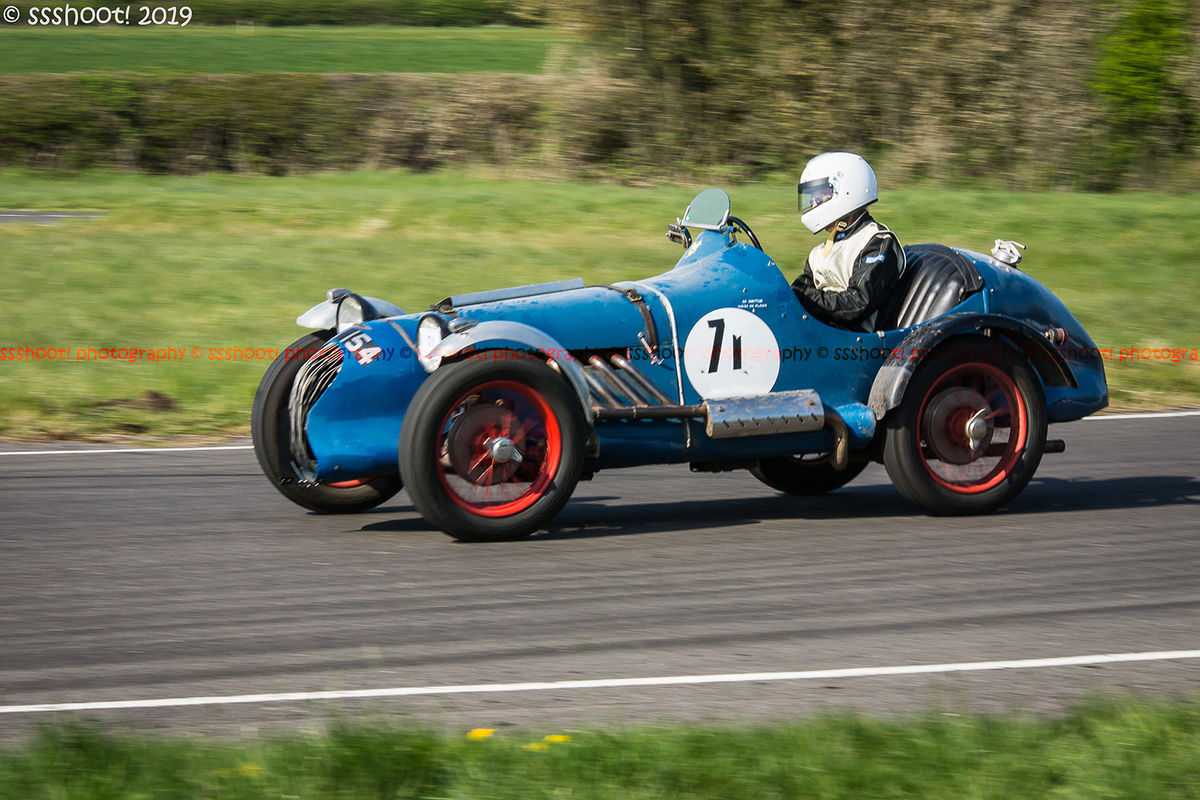 Blue vintage racing car at speed on curborough sprint course
