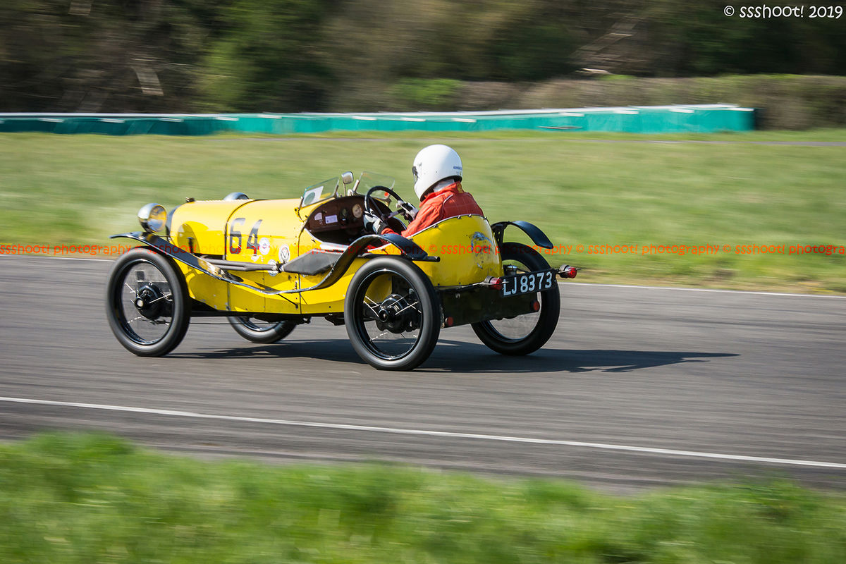 yellow vintage racing car at speed on curborough sprint course