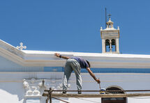 Painting the Panagia Evangelistria Church, Tinos.