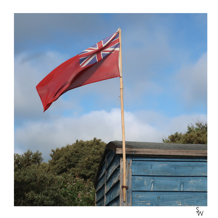 VINTAGE FLAG AND OLD RAILWAY CARRIAGE