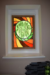 Greenman installed in an internal bathroom window back lit.