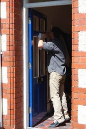 Ian fitting leaded and painted glass to replace the wood in the front