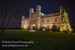 Front entrance of Leeds Castle at night with Christmas Tree