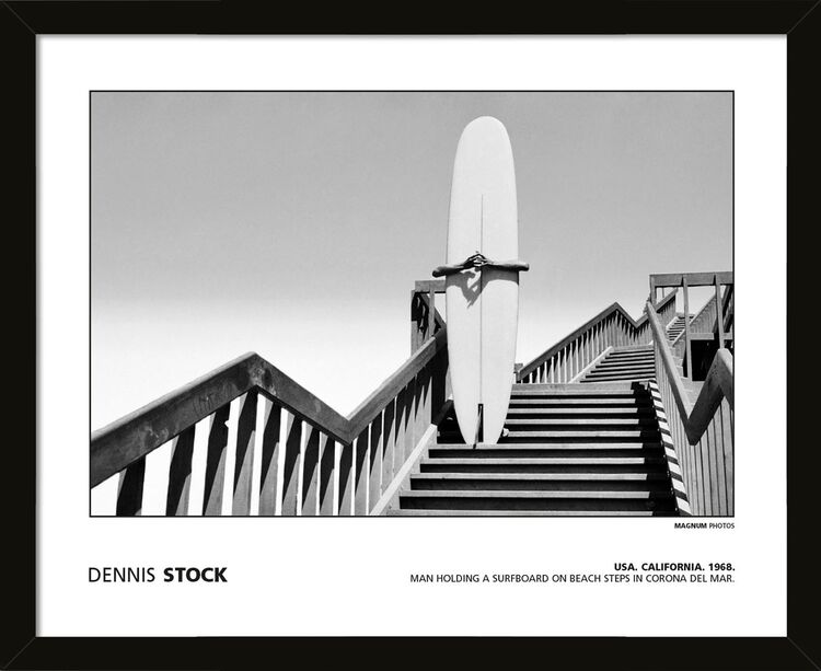 Dennis Stock - USA. California. 1968. Man holding a surfboard on beach steps in Corona Del Mar. Framed Art Print by Magnum Photos