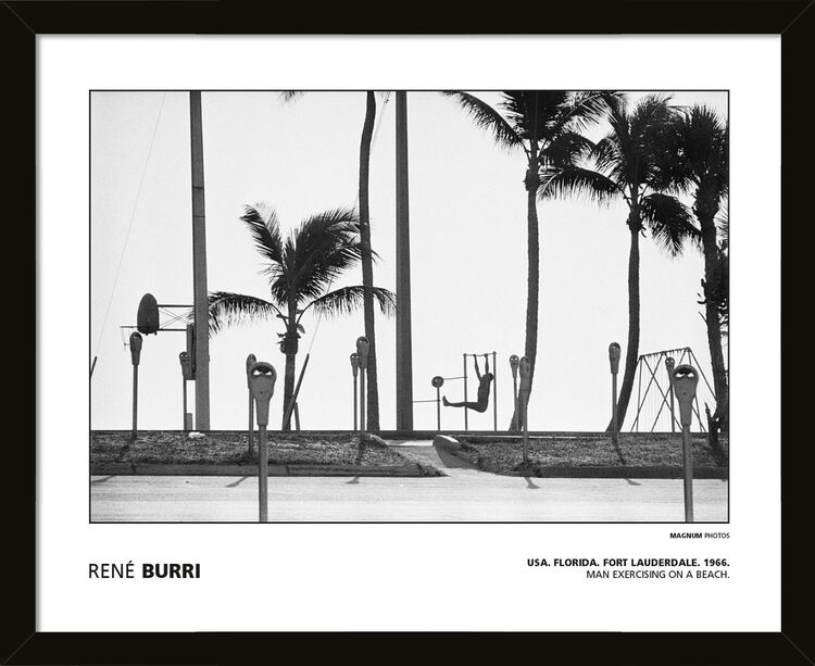 Rene Burri - USA. Florida. Fort Lauderdale. 1966. Man exercising on a beach. Framed Art Print by Magnum Photos
