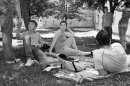 Students from Sarajevo sit under the tree on a summer afternoon in the park