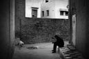 Man sits on the threshold of the house
