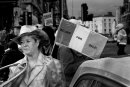Woman in hat holding Irish flag with written Ireland for sale on it