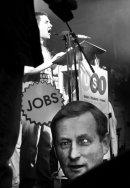 Speaker addresses the crowds during demonstration, Dublin, 2011 with Taoiseach paper head in the foreground