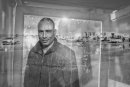 Young unemployed man portrait, village in the background, Tunisia