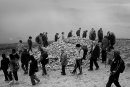 People circle around stone cairn during Croagh Patrick pilgrimage
