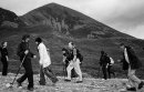 People walks with the sticks, summit of Croagh Patrick in the backgroud