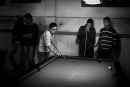 a group of teenagers play snooker