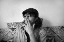 the student in the cap smokes a cigarette